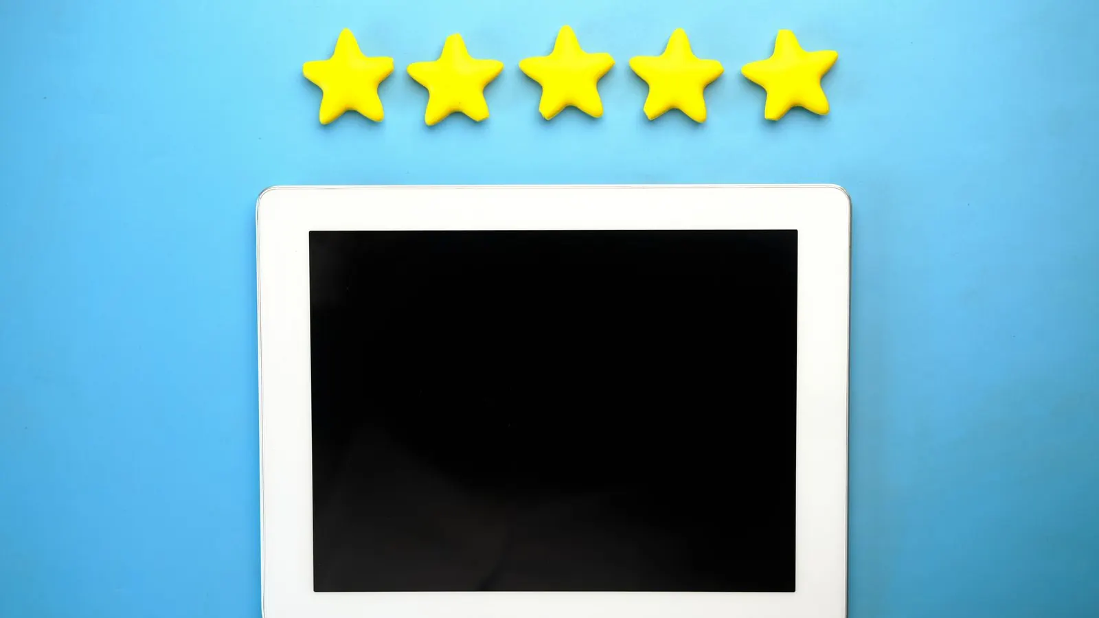 Five gold stars above a tablet on a blue background