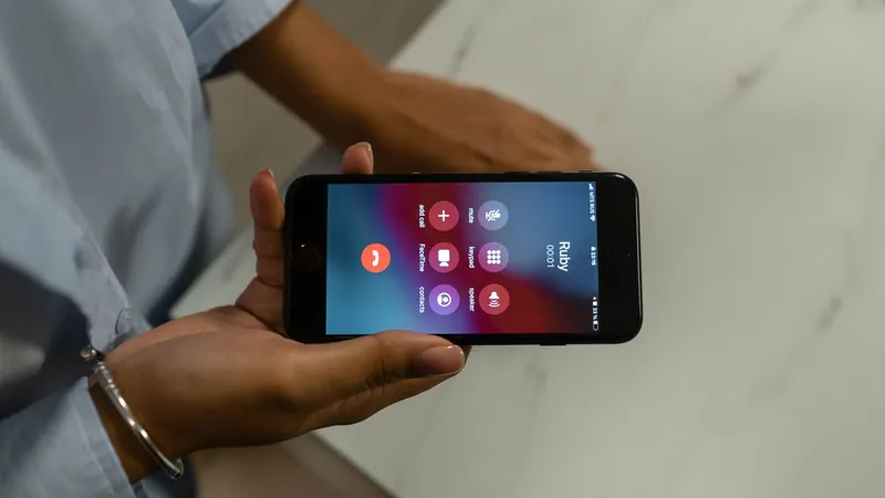Hand holding a smartphone showing an incoming call
