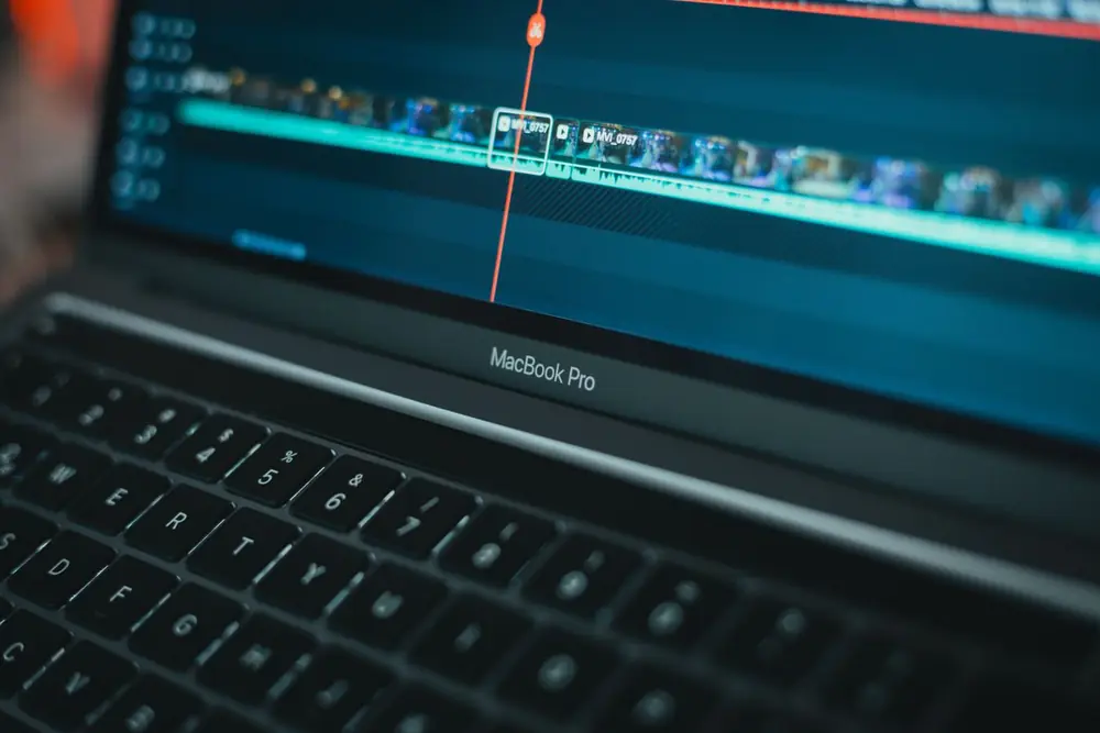 Short video clips being edited on a laptop timeline