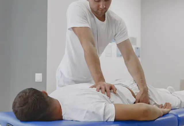 A chiropractor treating a patient on a table, from the chiropractic website template.