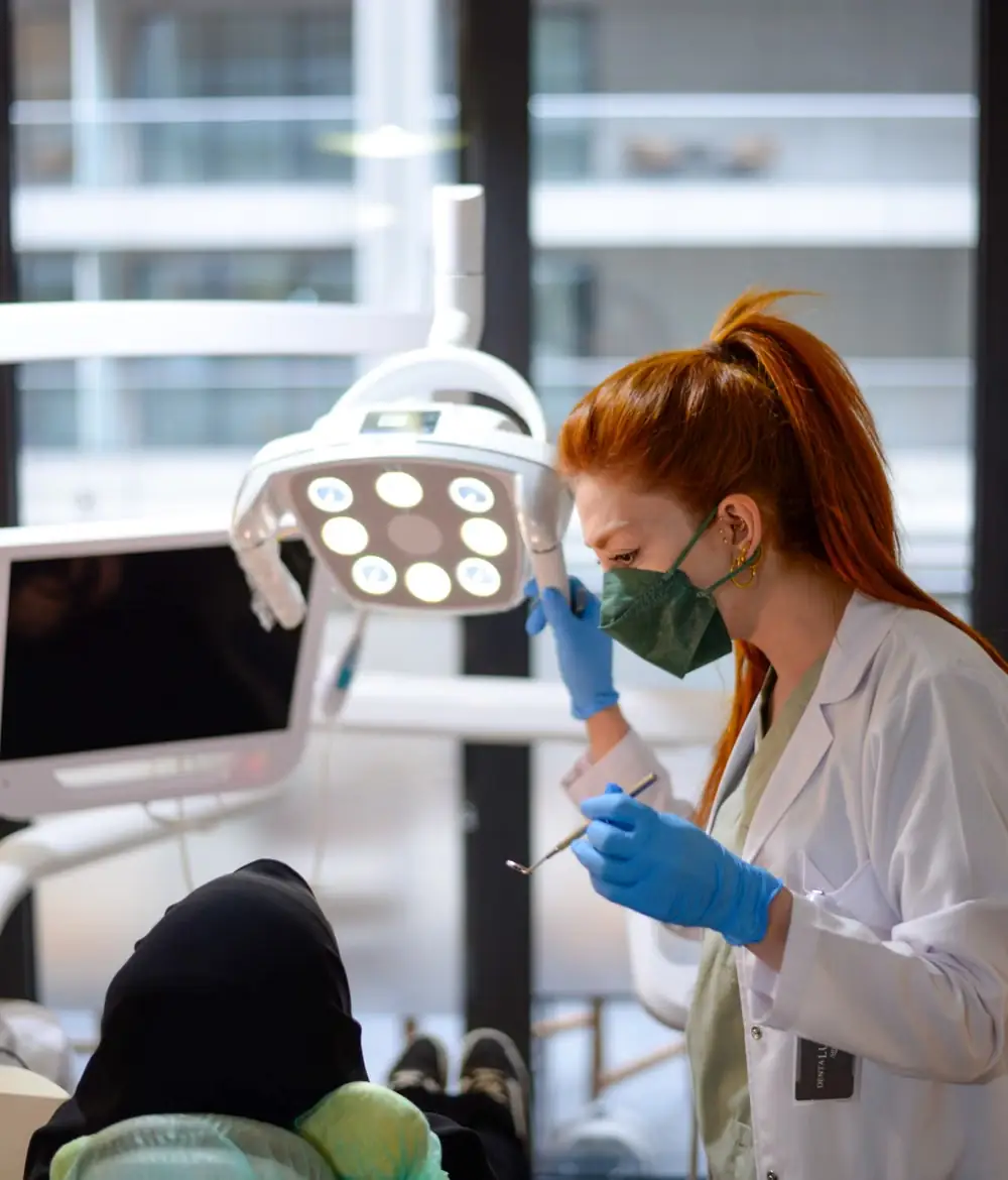 A dentist at work under the operatory light