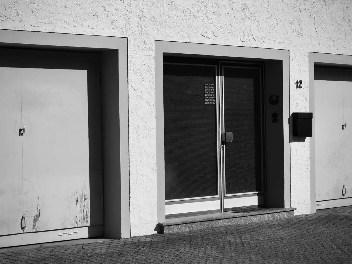 A row of garage doors photographed in black and white