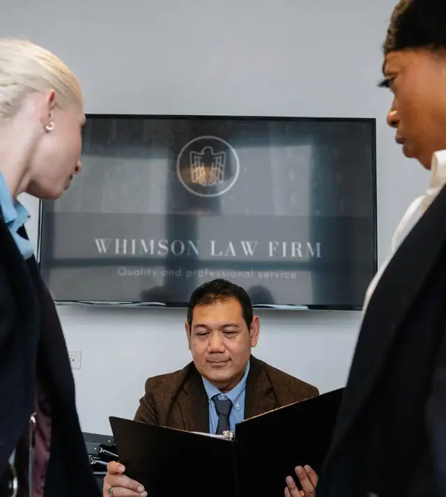 Attorneys reviewing a case file together in a law office, from the law firm website template.