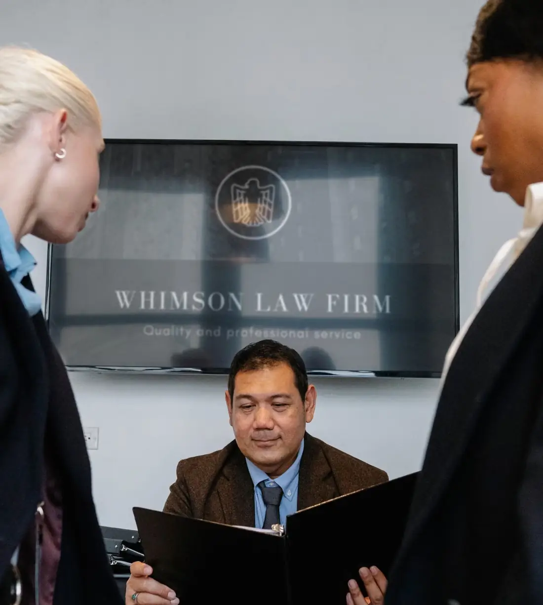 Attorneys reviewing a case file together in a law office
