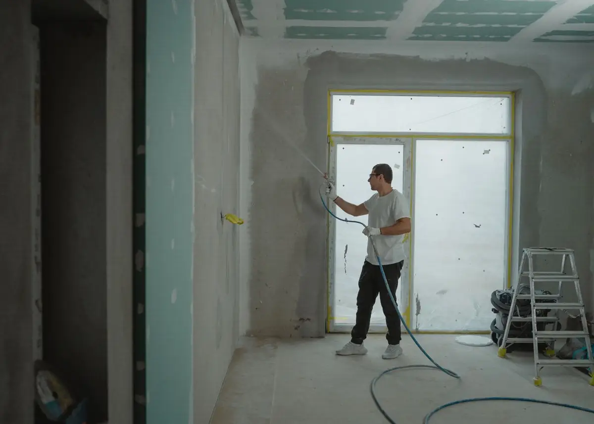 A tradesperson working on a room mid-renovation