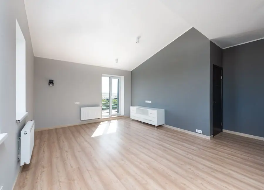 A bright renovated open-plan room with new flooring