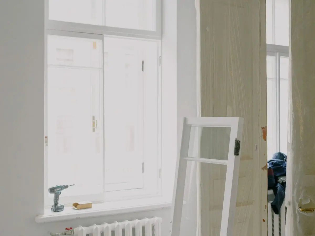 A room part-way through renovation with a door and tools